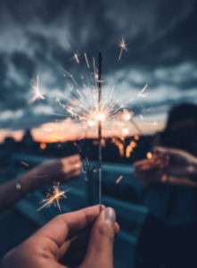 A woman's hand holding a sparkle in celebrating family business milestones