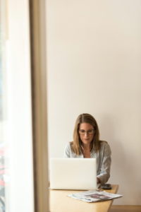 The Business Women is working at her computer in the office